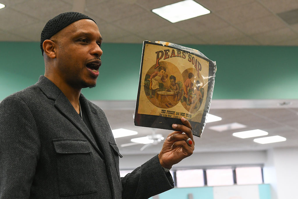 Khalid el-Hakim, curator and founder of the Black History 101 Mobile Museum, presents artifacts from America's racist past